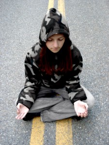 meditating on street - maslows needs